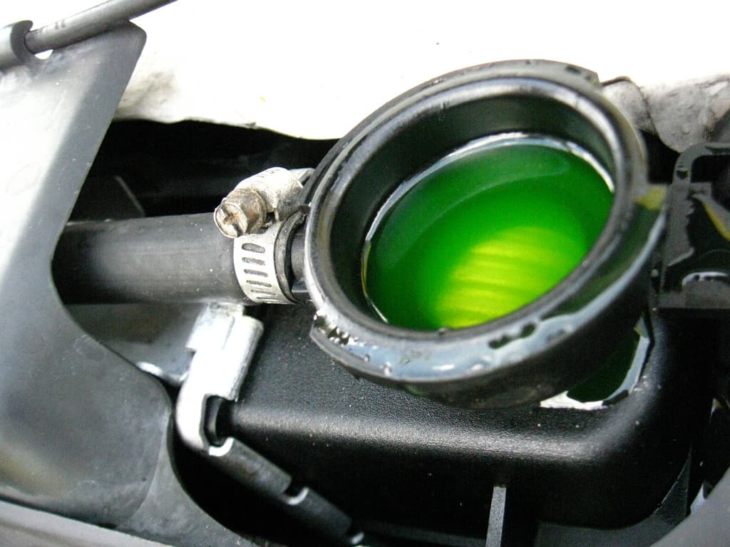 Coloured antifreeze coolant visible through the filler neck of a car radiator