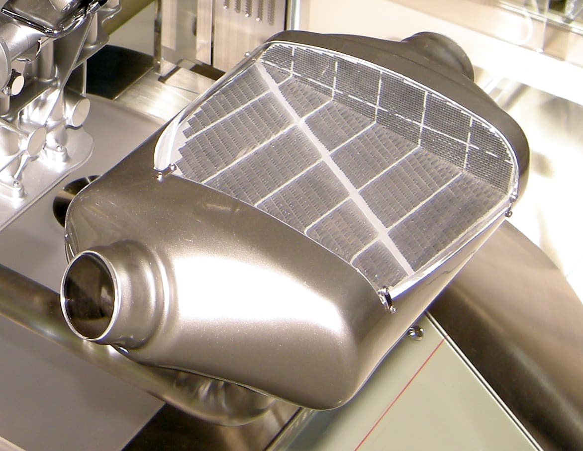 A diesel particulate filter unit removed from a vehicle: a metal exhaust canister housing the ceramic wall-flow element that traps soot from the exhaust stream.