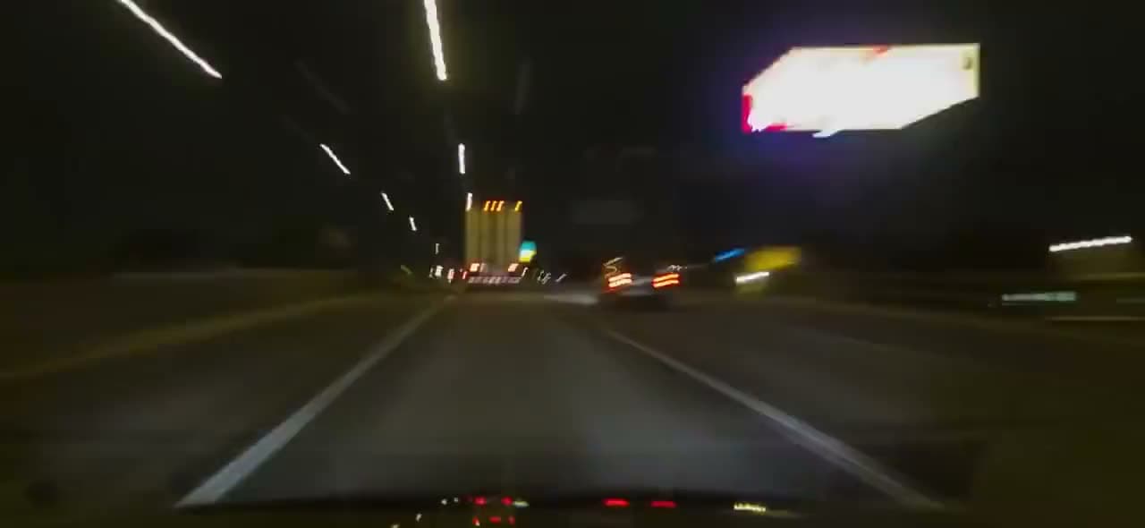 City traffic streaking past at night