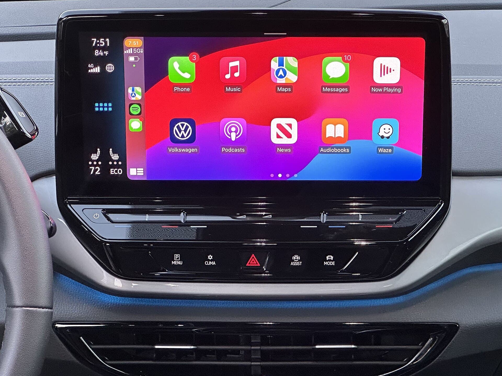 A car's dashboard touchscreen showing the Apple CarPlay home screen with app icons.