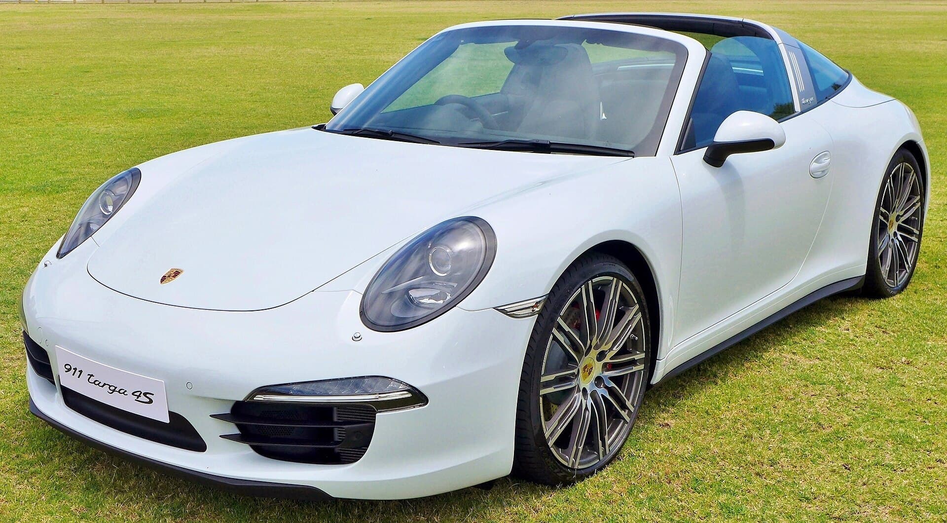 A white Porsche 911 Targa 4S parked on a grass lawn in South Perth