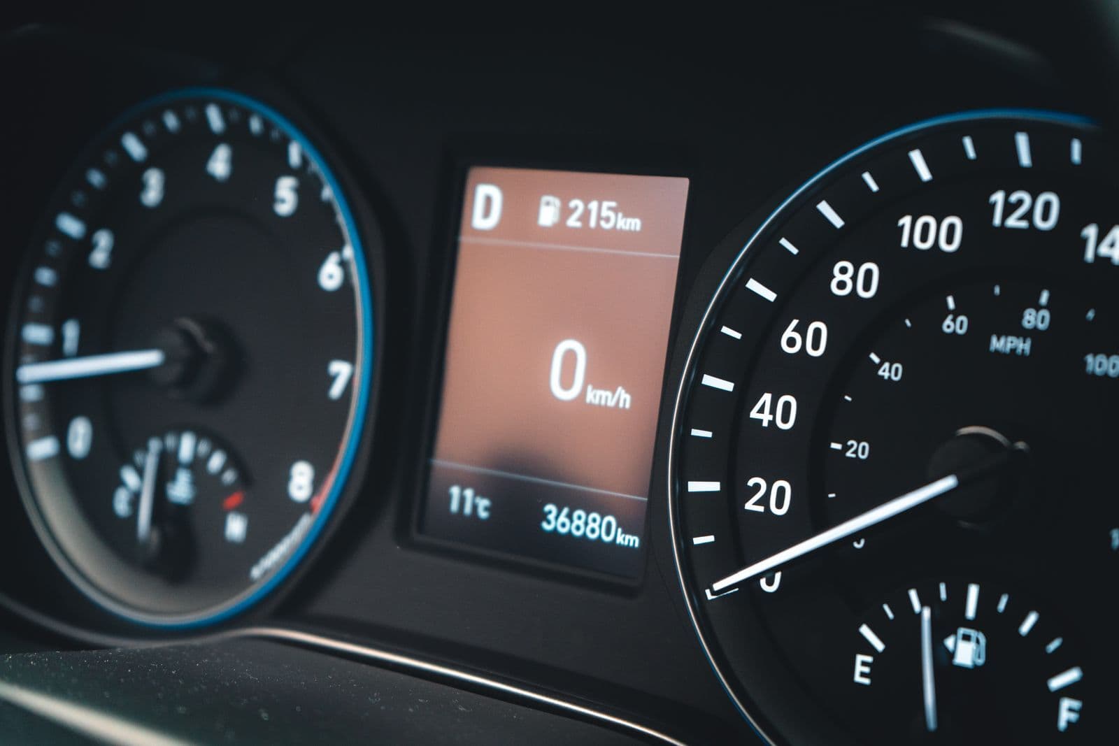 A car instrument cluster with a digital display reading 36,880 km beside the speedometer and rev counter.